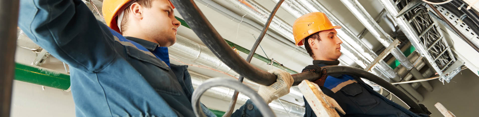 Workers installing electrical cables