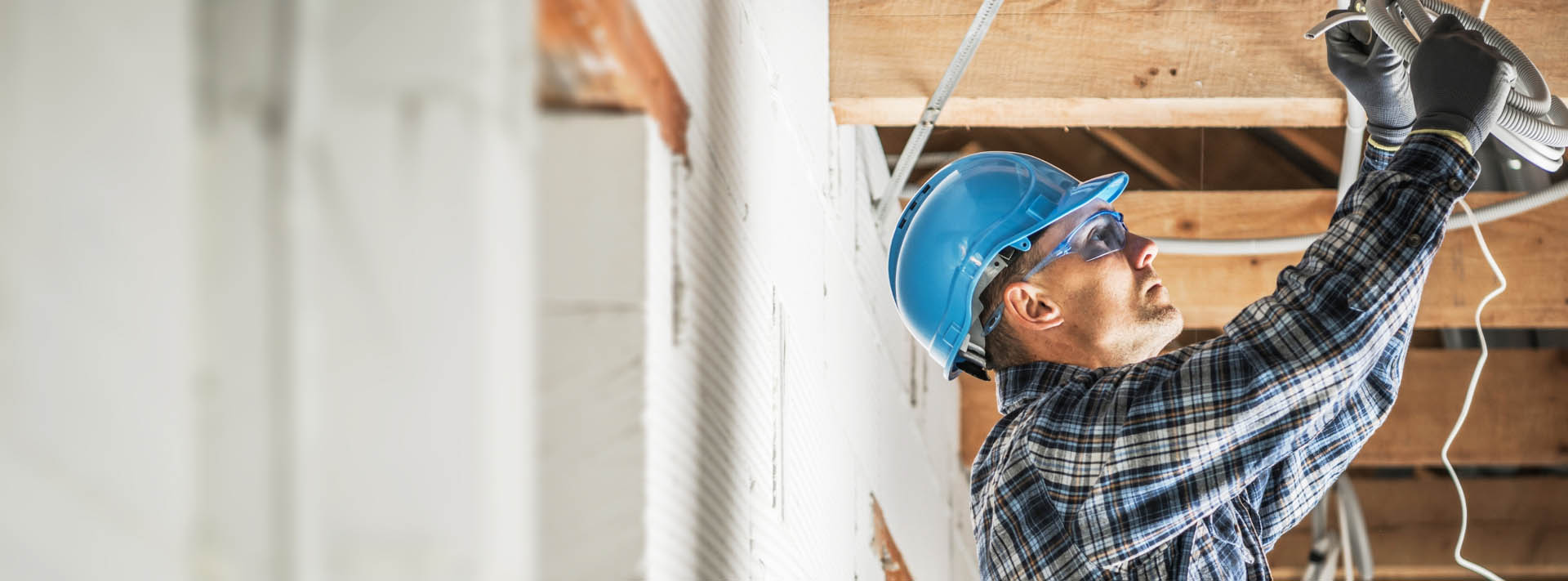 Worker installing electrical wiring