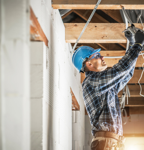 Worker installing electrical wiring